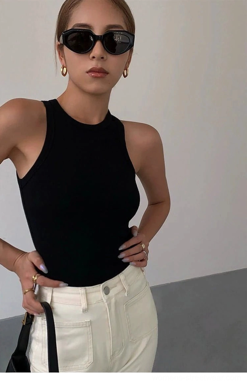 Ribbed knit tank top styled with white sneakers and minimal accessories for casual streetwear aesthetic