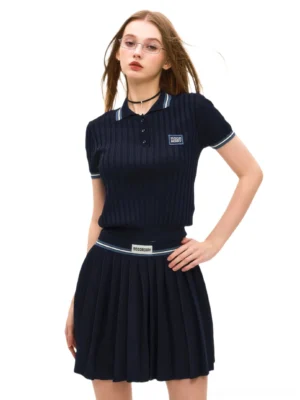 Dark blue ribbed polo and pleated mini skirt Korean preppy streetwear outfit on model