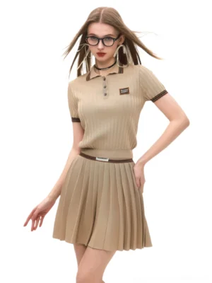 Khaki ribbed polo and pleated mini skirt preppy streetwear outfit front view on model