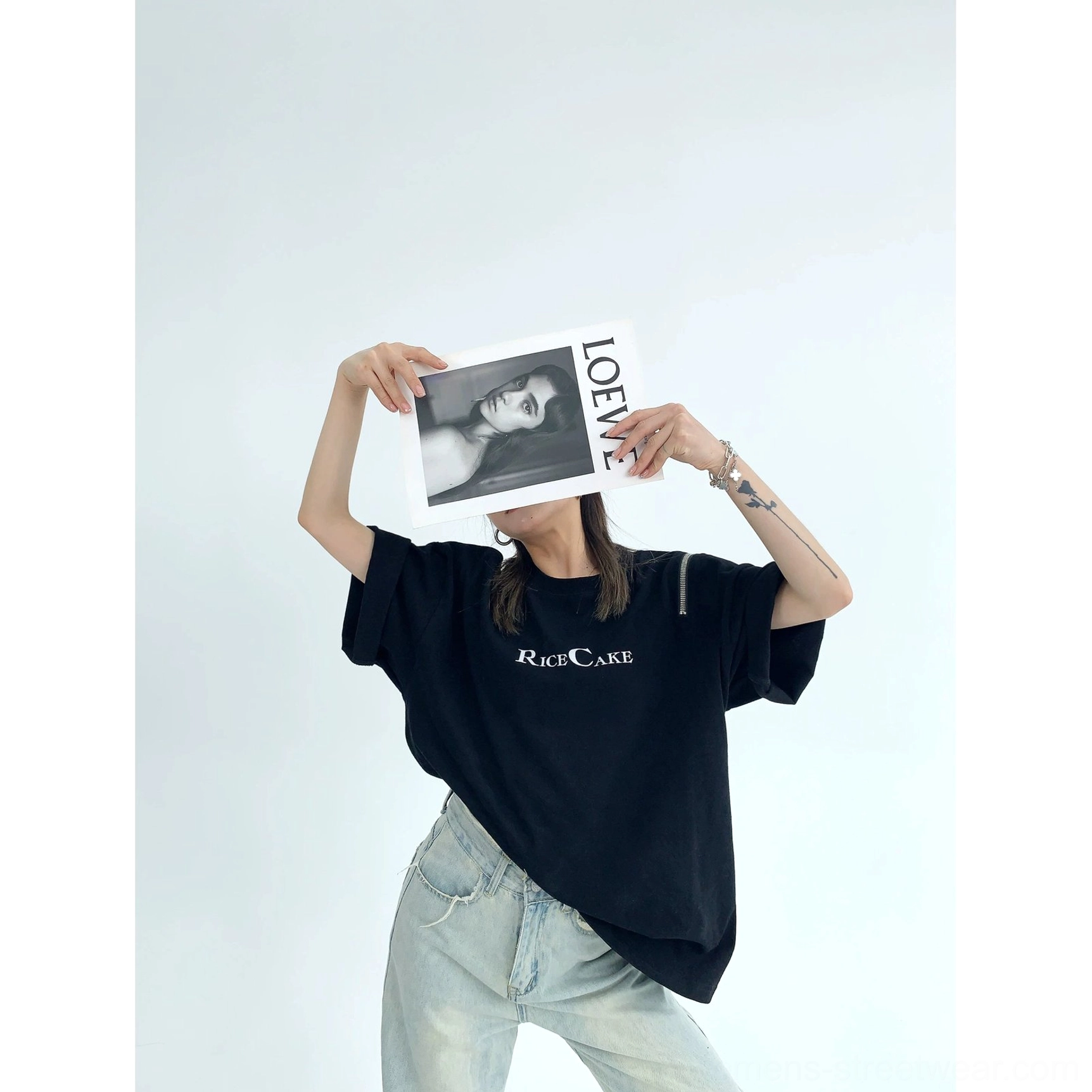 Black RICE CAKE oversized streetwear graphic tee with metal shoulder hardware styled in a casual denim outfit