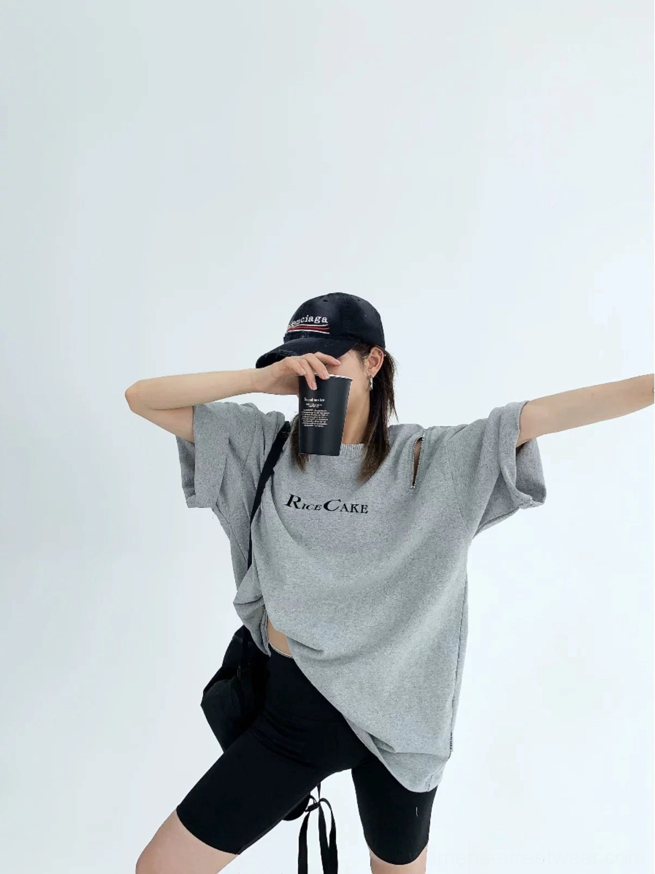 Heather gray oversized RICE CAKE graphic tee with zip shoulder cutout styled with a black crossbody bag