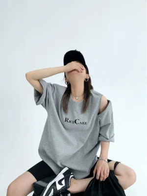 Heather gray RICE CAKE zip shoulder cutout oversized streetwear tee shown from the front in a seated outfit