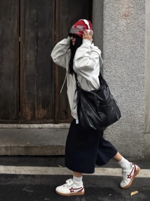 Female streetwear outfit wearing rice red star panel retro trainers with gray hoodie, wide-leg black pants and red beanie