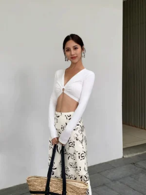 White ring detail plunge long sleeve crop top styled with floral maxi skirt outdoors