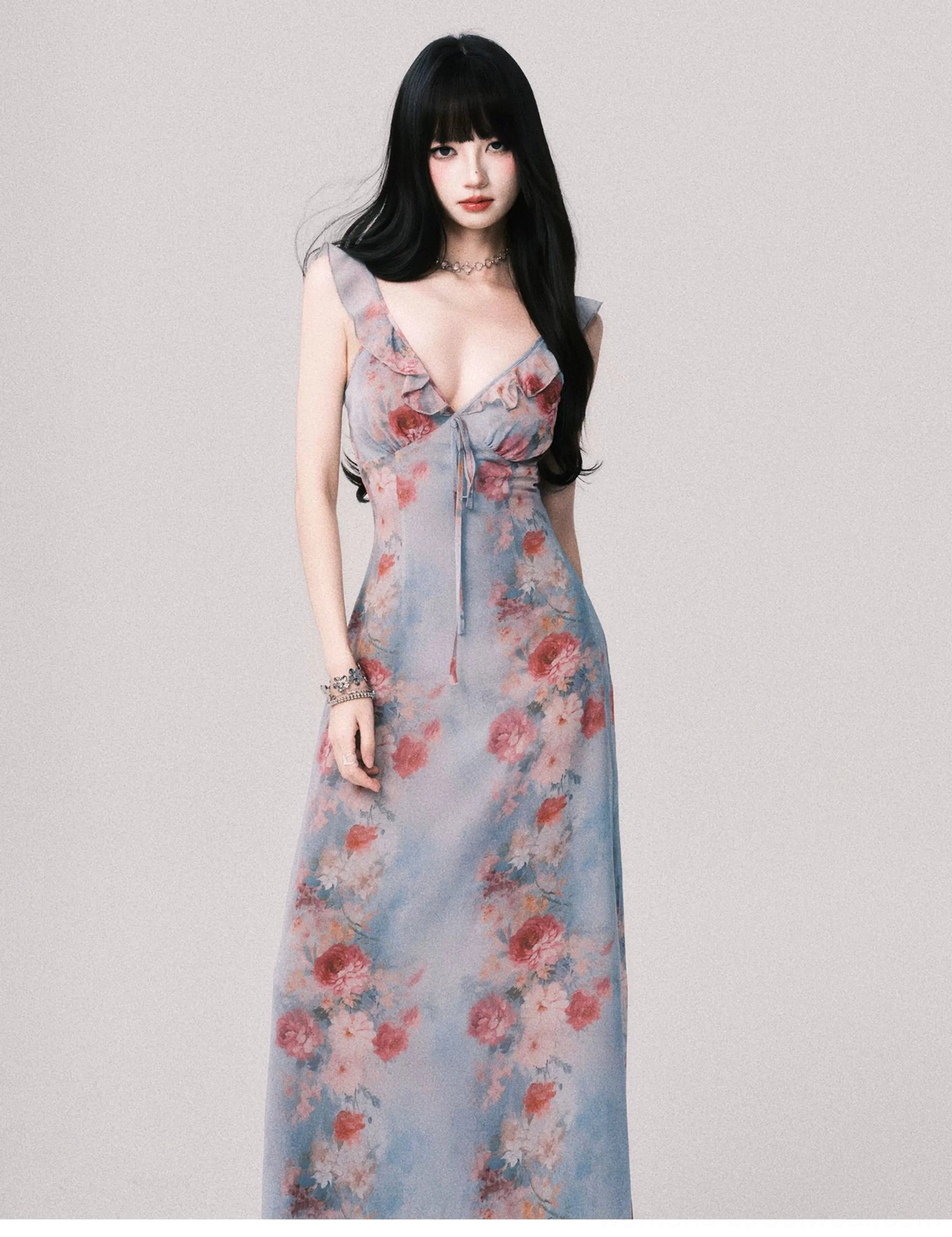 Romantic foggy blue floral maxi slip dress front view featuring ruffled shoulder straps V-neck tie and long flowing skirt