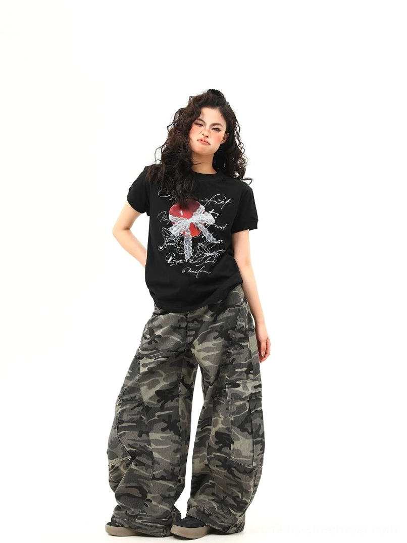 Full body front view of black heart bow script graphic T-shirt in a relaxed Y2K streetwear outfit