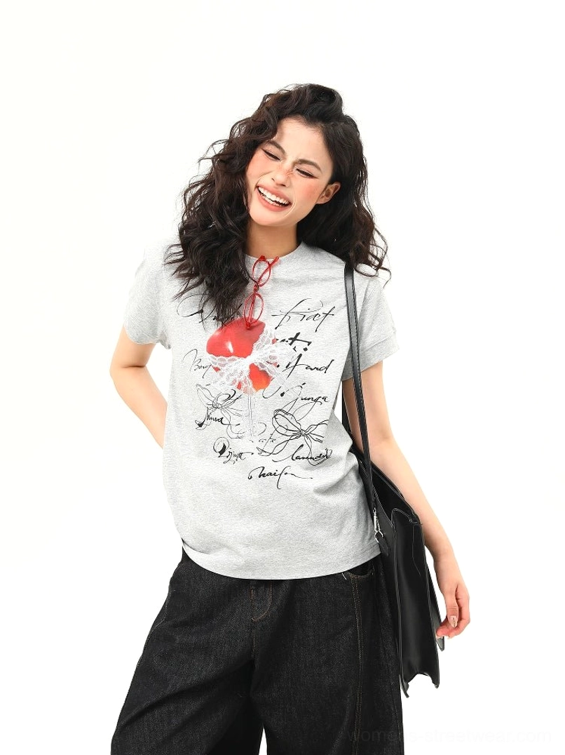 Heather gray romantic heart bow script graphic T-shirt paired with black wide-leg jeans and shoulder bag