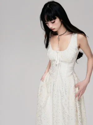 Close up of beige romantic lace maxi dress featuring ruched bust self tie detail and embroidered floral lace