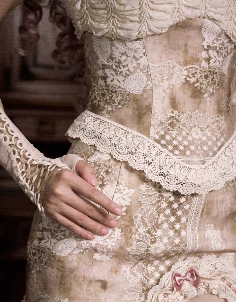Romantic lolita inspired lace patchwork corset top featuring cream fabric, heart appliqué details, ruched construction, and scalloped lace edging