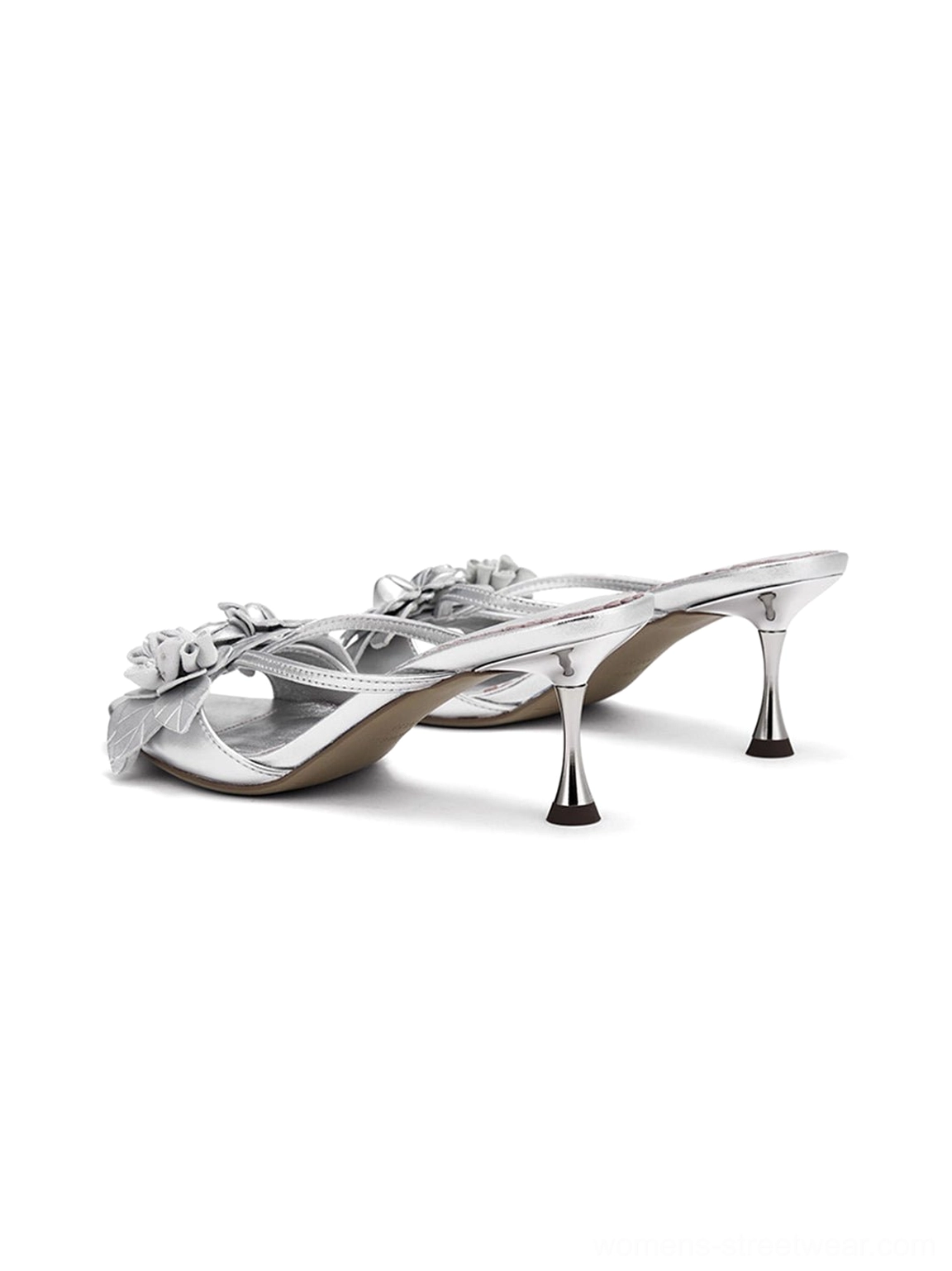 Romantic floral kitten heel sandals in metallic silver with sculptural flower accents, open toe styling, and contemporary streetwear appeal