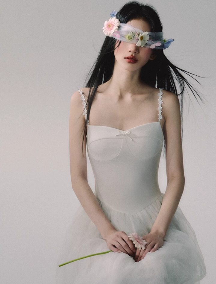 Romantic white sweetheart tulle gown with delicate lace strap detailing for weddings, formal events, and editorial styling