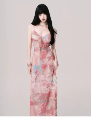 Front full-body view of a pink rose mosaic floral patchwork maxi slip dress with ruched sweetheart bust, front tie, spaghetti straps, and long fitted silhouette