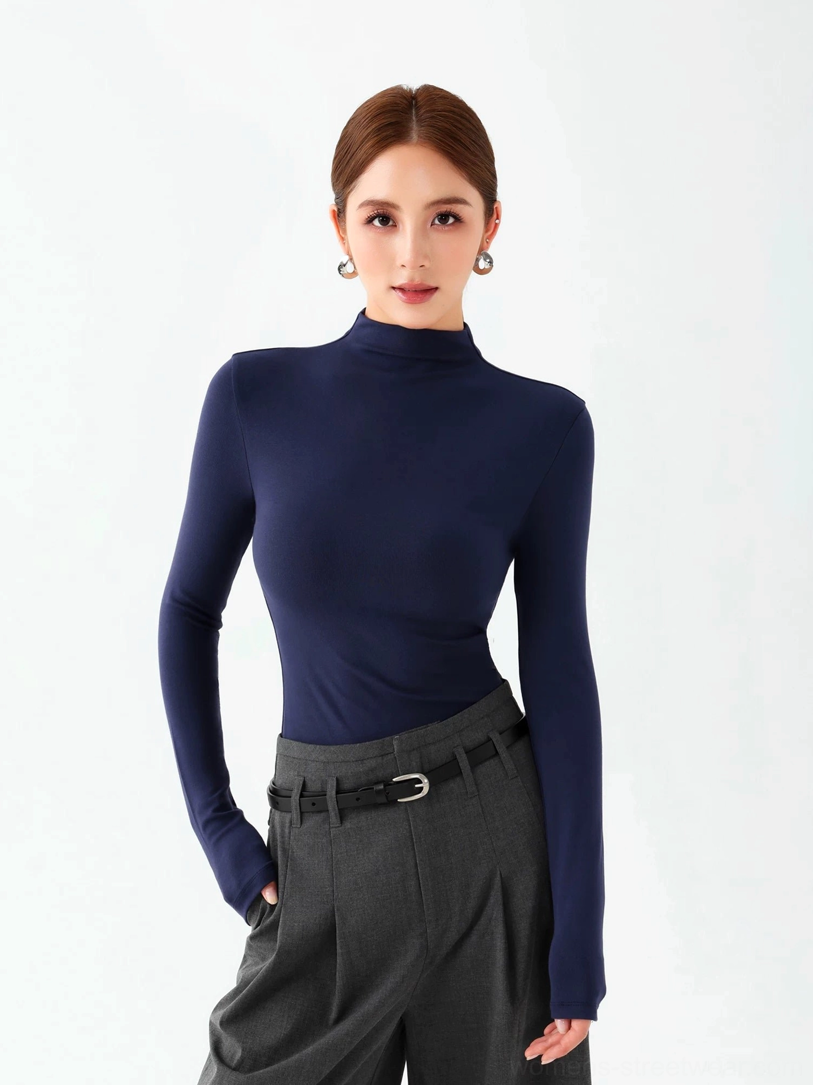 Royal blue women's mock neck long sleeve knit top styled with high waisted gray tailored trousers