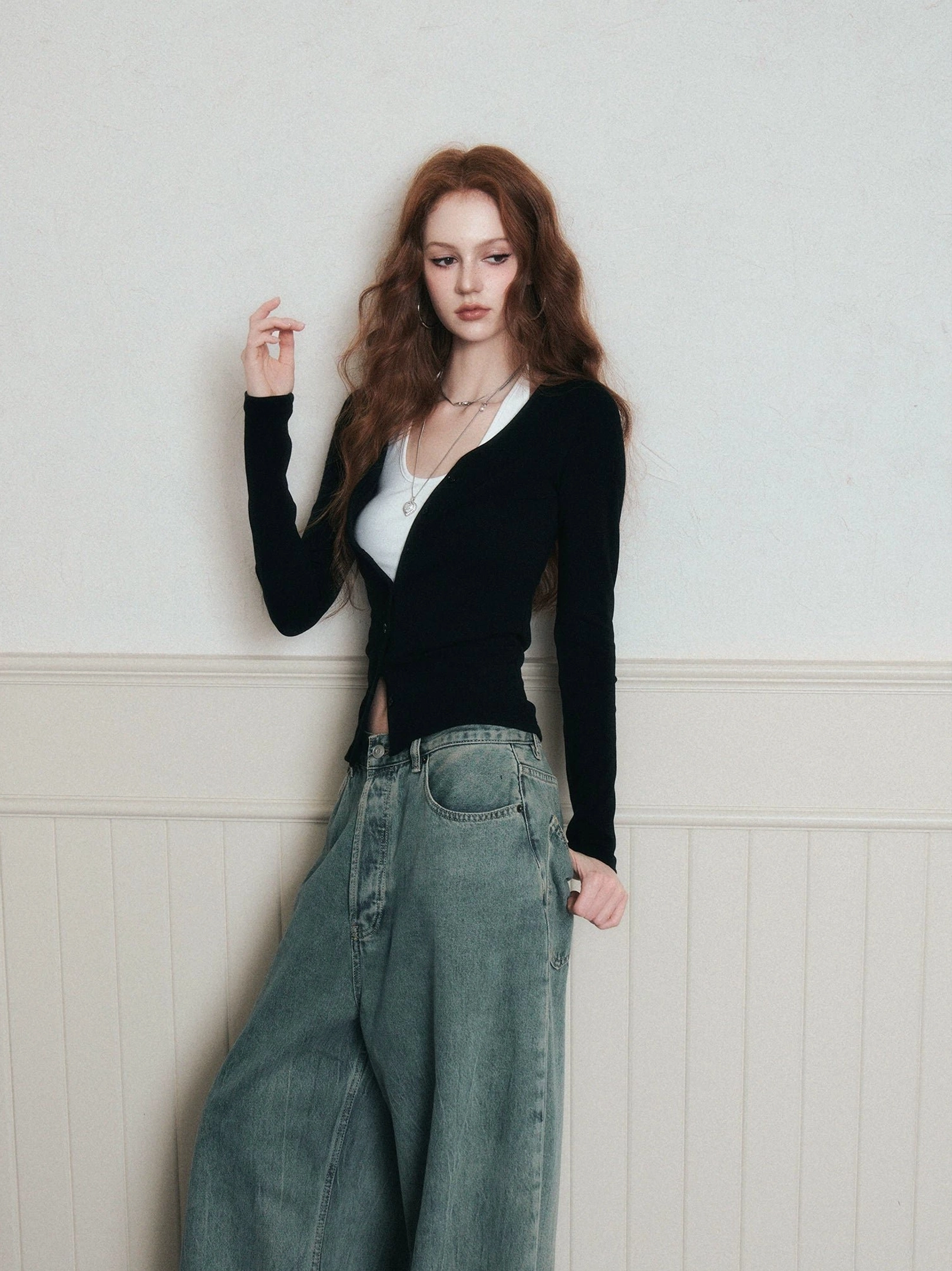 Black ruched layered knit cardigan and white halter top set shown in a three-quarter front view