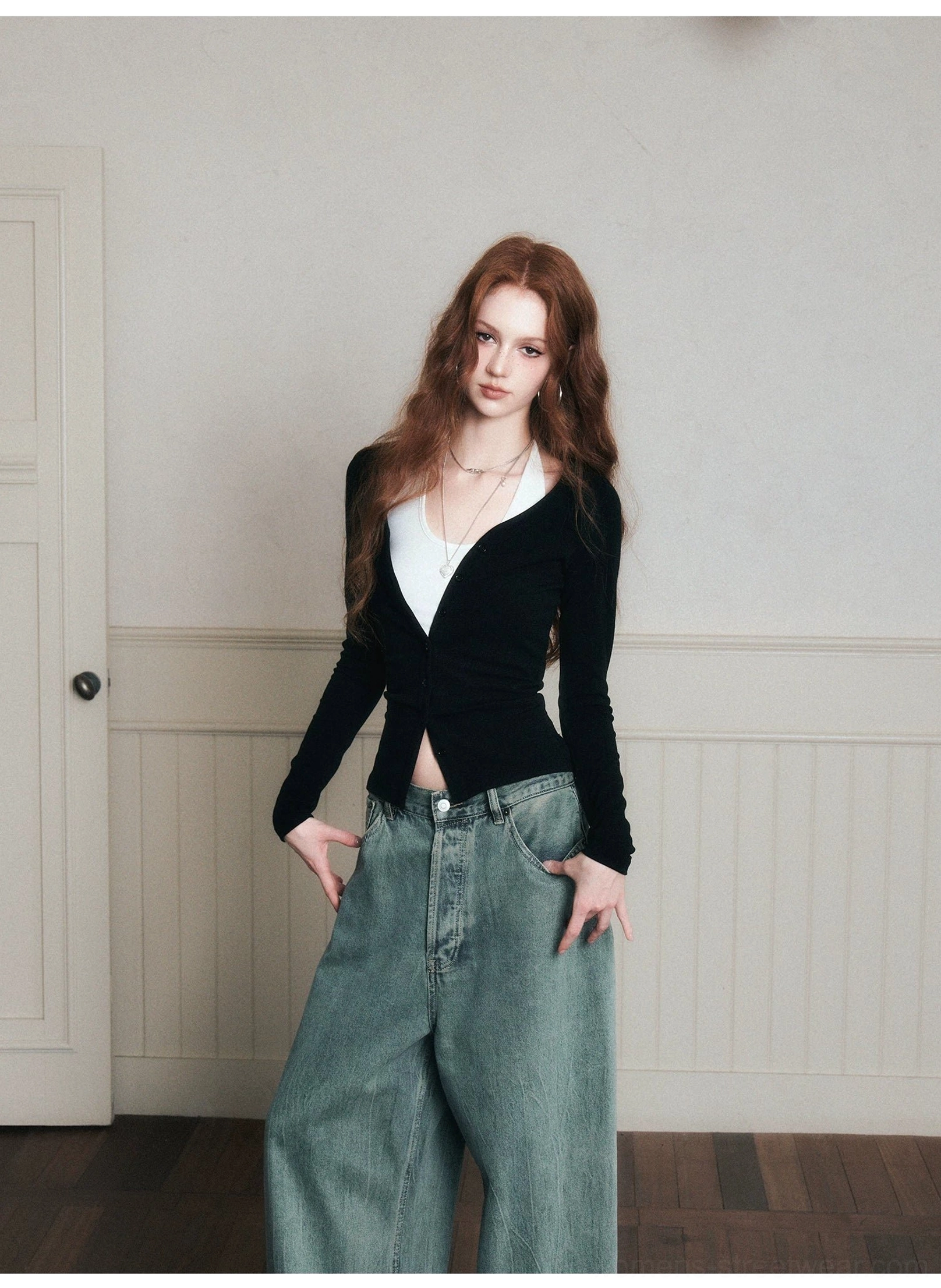 Black ruched cardigan and white halter camisole layered top with blue wide-leg denim