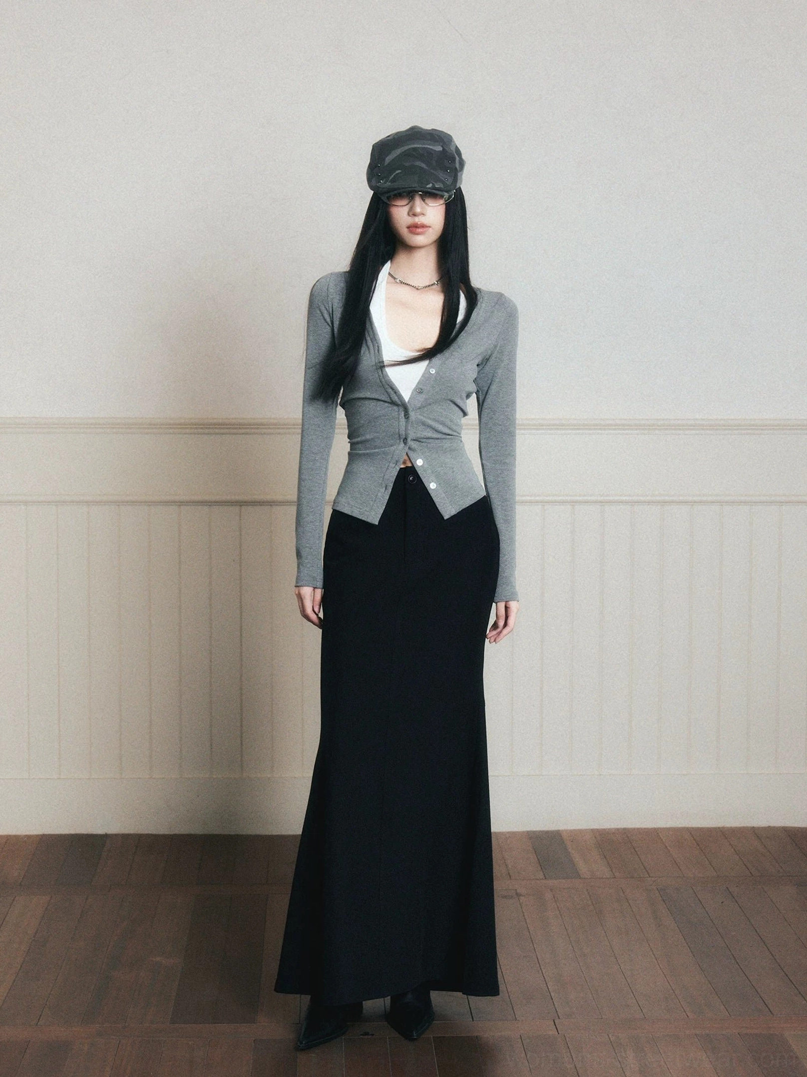 Gray ruched layered knit cardigan and halter top styled with a black maxi skirt