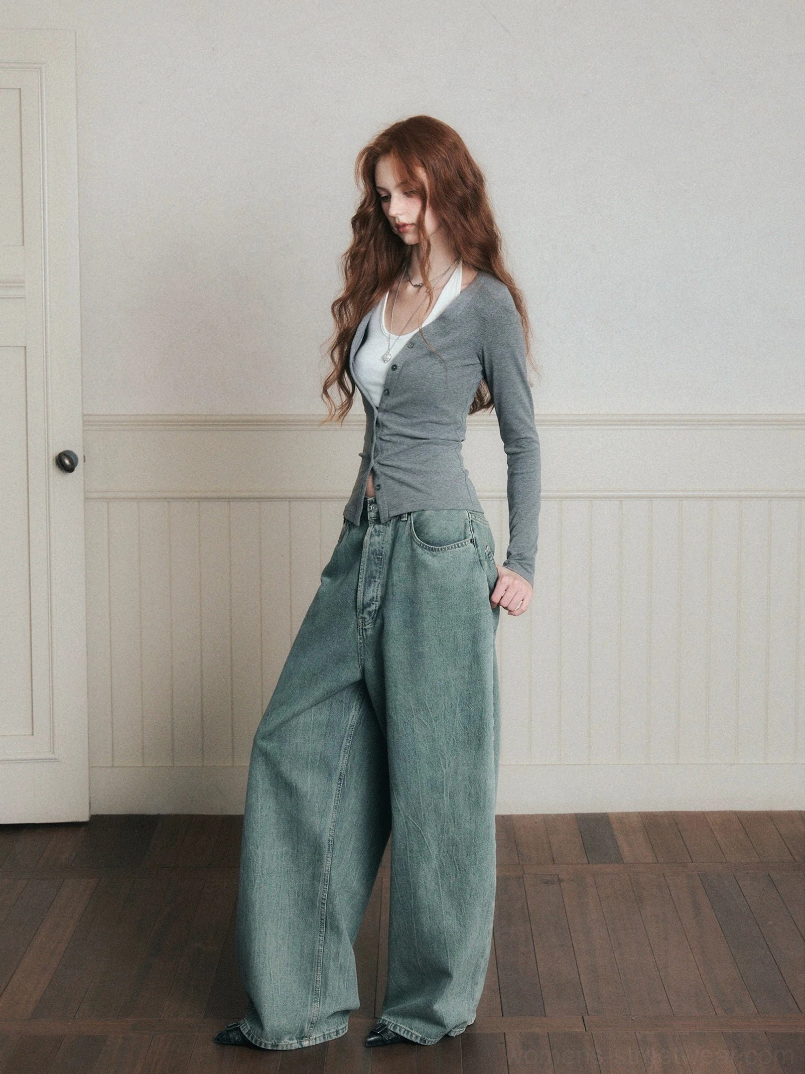 Heather gray fitted layered knit cardigan with white halter camisole shown in side view