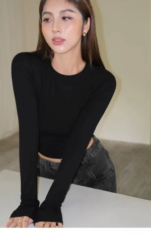 Black ruched second-skin cropped long sleeve crew neck top with thumbhole cuffs front close-up