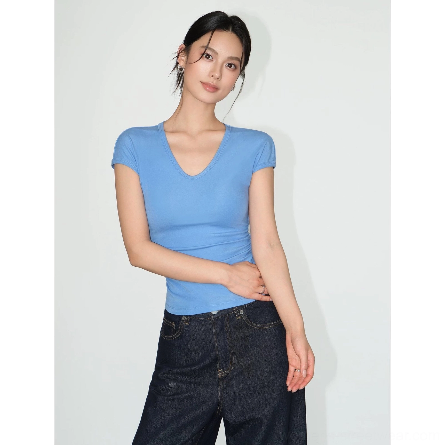 Blue ruched V-neck sculpting knit baby tee for women with a fitted waist and short sleeves