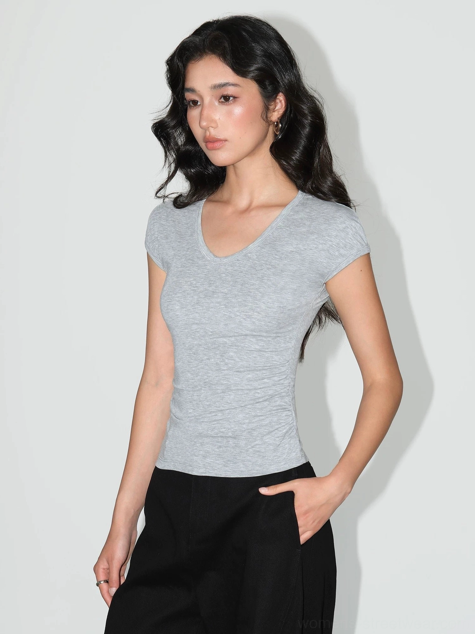 Heather gray ruched V-neck sculpting knit baby tee for women showing the waist-hugging fit