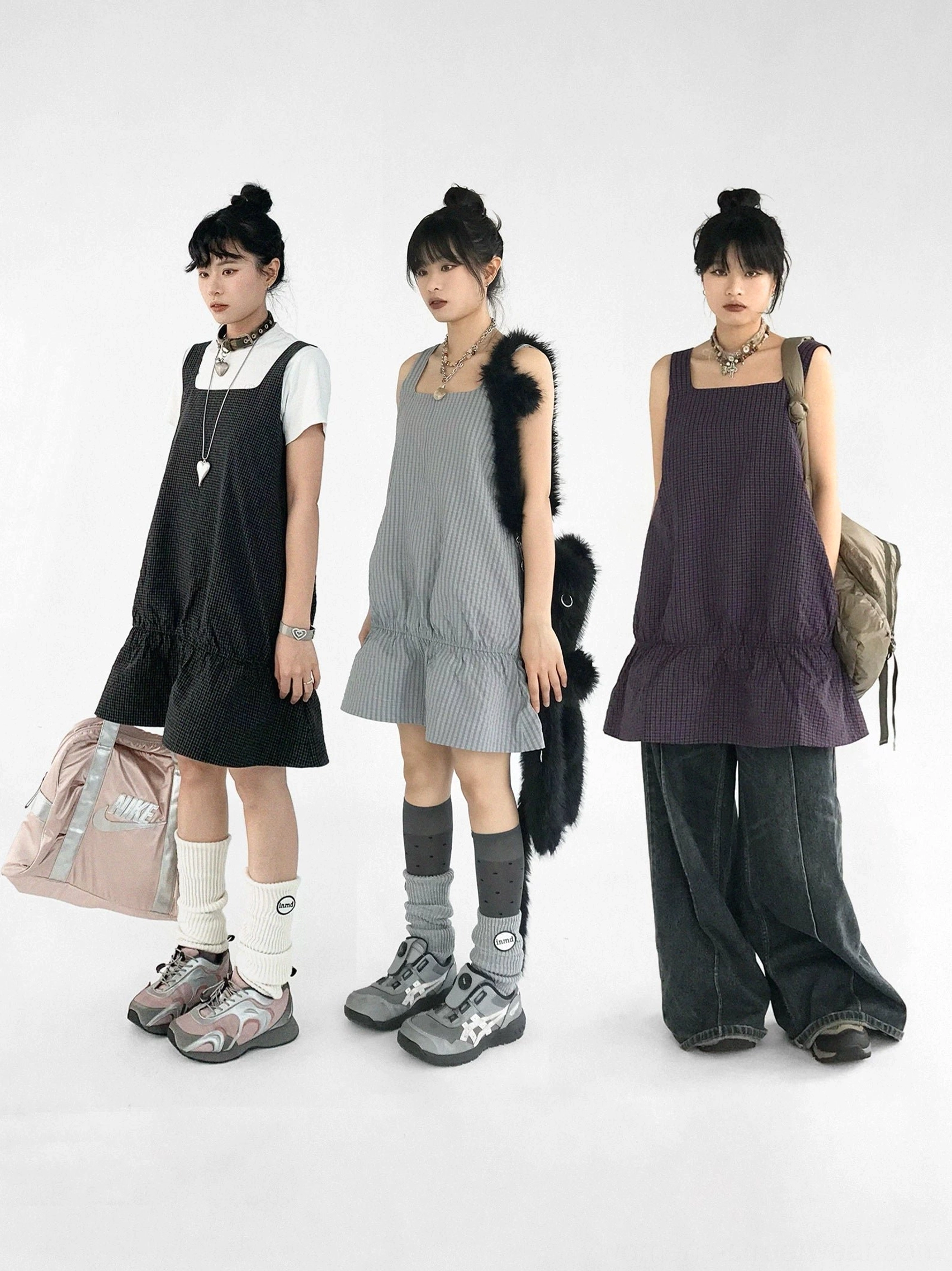 Berry black and gray gingham ruffled pinafore mini dresses layered over white t shirts in Korean streetwear styling