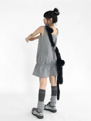 Gray gingham ruffled pinafore mini dress back view styled with knee high socks sneakers and fuzzy crossbody bag