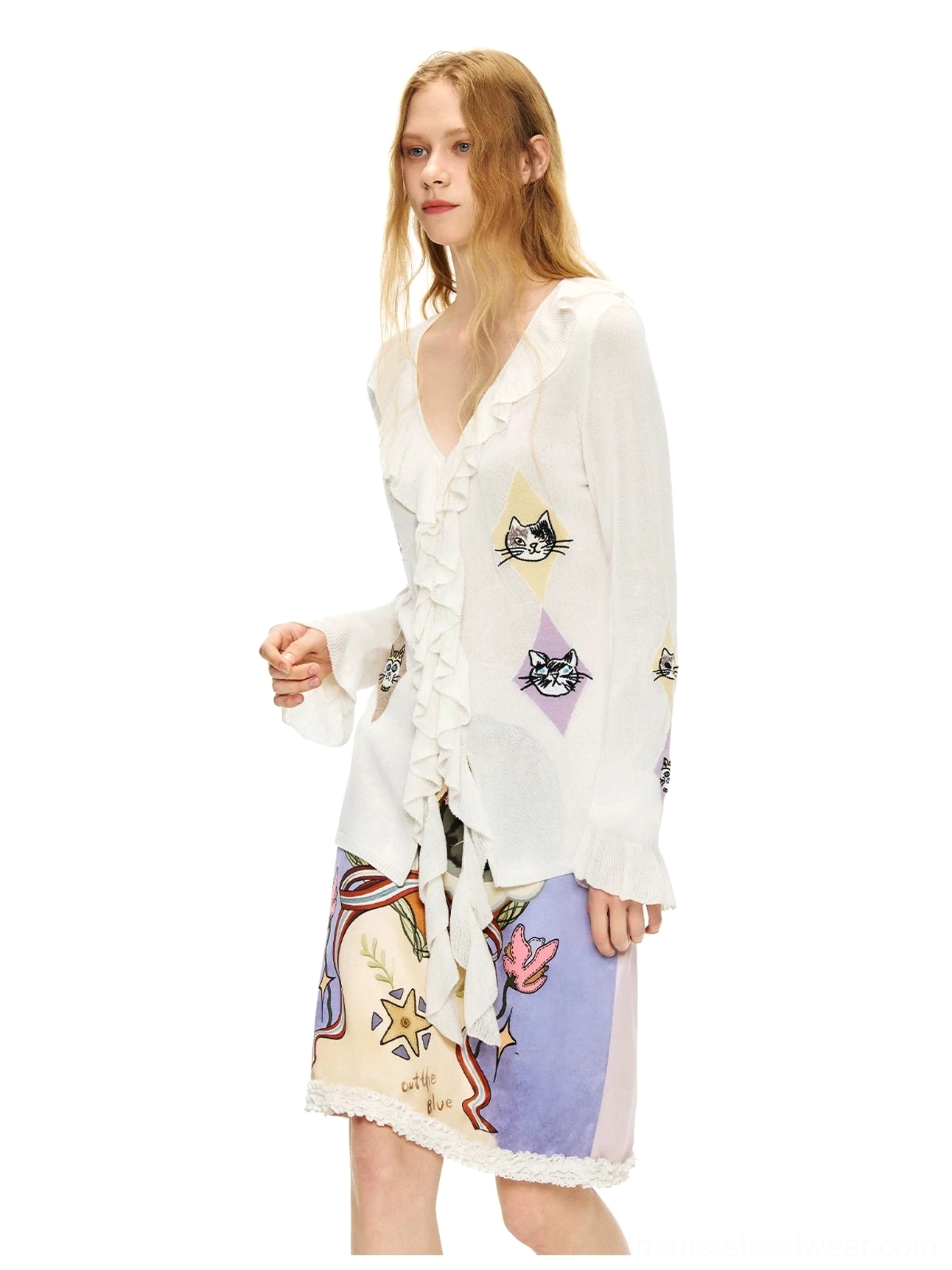 Side studio view of the ruffled kitty argyle sheer knit cardigan blouse with cat diamond motifs and romantic printed mini skirt
