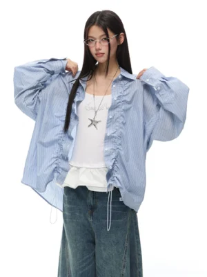 Light blue striped ruffled oversized long sleeve shirt styled with a white camisole and wide leg denim jeans