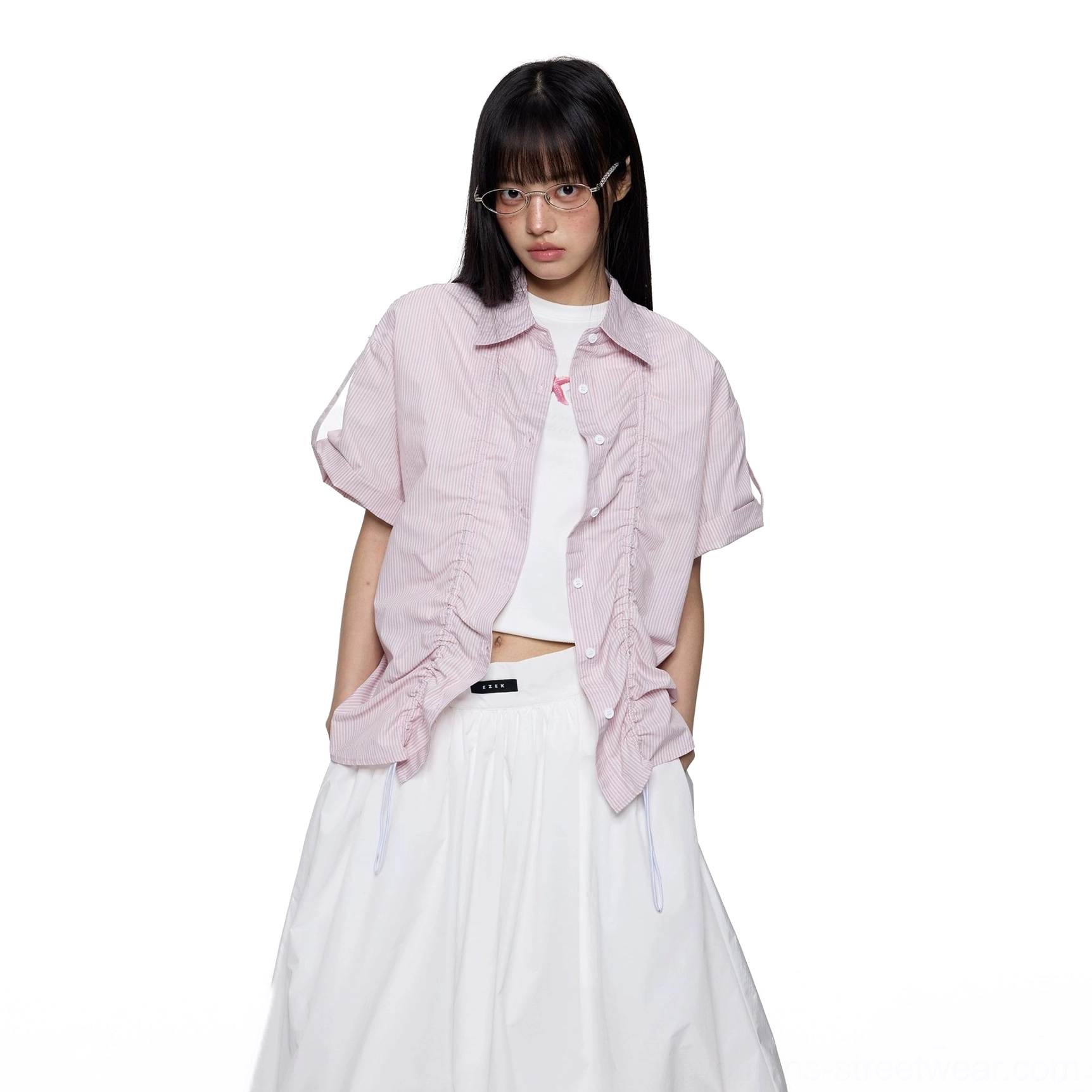 Pastel pink cropped short sleeve ruffled oversized shirt layered over a white camisole and voluminous midi skirt