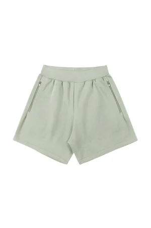 Muted sage green cotton blend streetwear shorts with elastic ribbed waistband and side zipper pockets shown on a white background