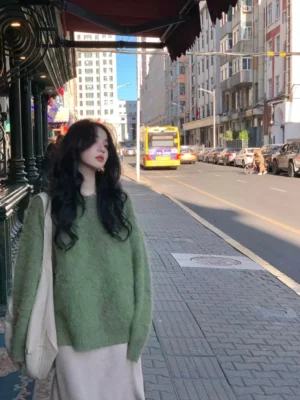 Sage green fuzzy knit sweater with relaxed oversized silhouette and soft brushed texture styled with a light flowing skirt and canvas tote bag