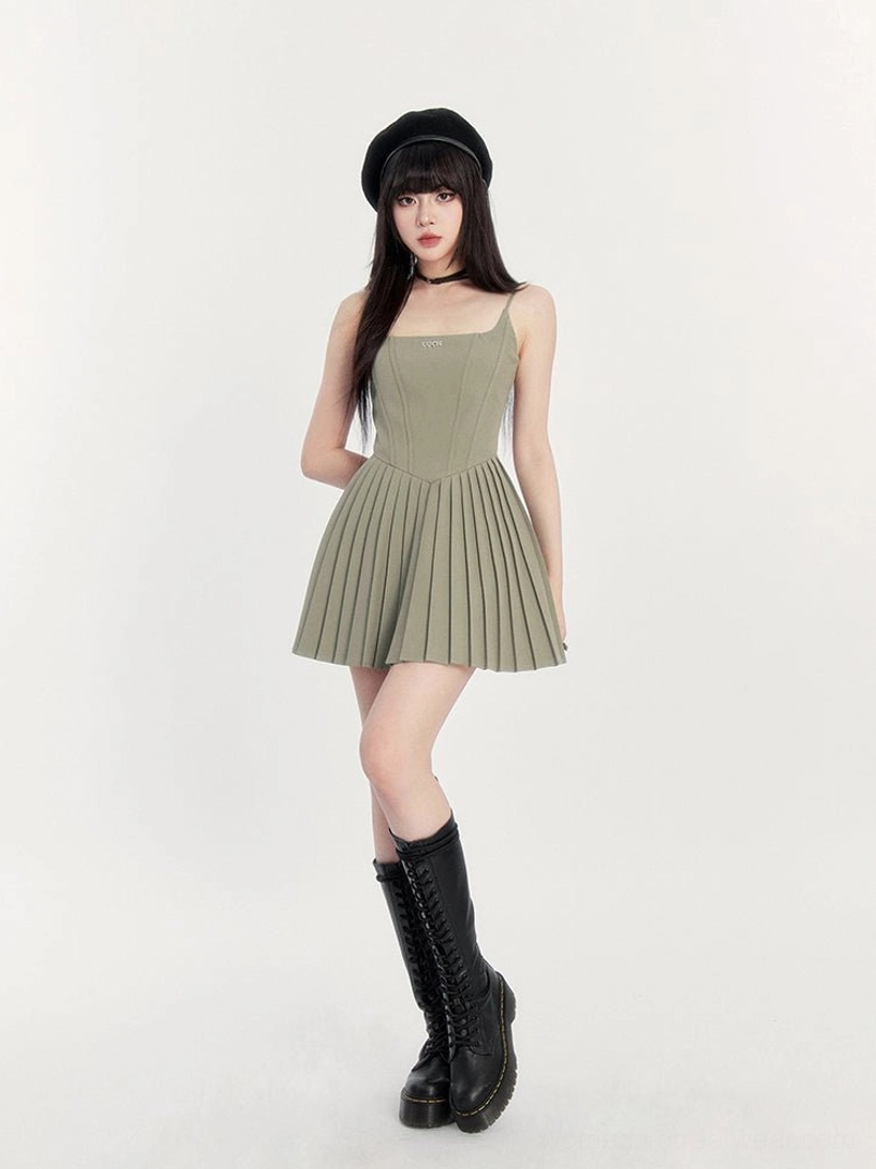 Sage green gothic cami mini dress shown from a three-quarter angle with fitted bodice pleated skirt and platform boots