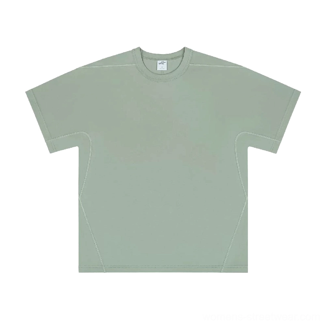 Front flat lay of a muted sage green loose-fit cotton T-shirt with dropped shoulders and tonal topstitching details
