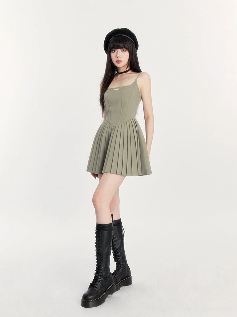 Sage green pleated spaghetti strap mini dress side view with fitted waist and flared alternative fashion skirt