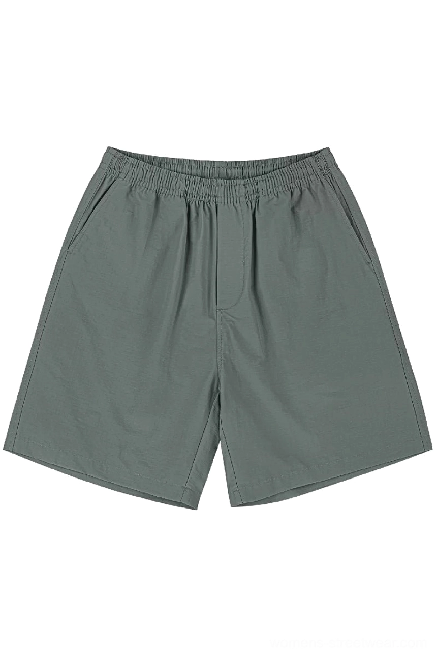 Sage green relaxed cotton streetwear shorts with elastic waistband and clean straight-leg summer design