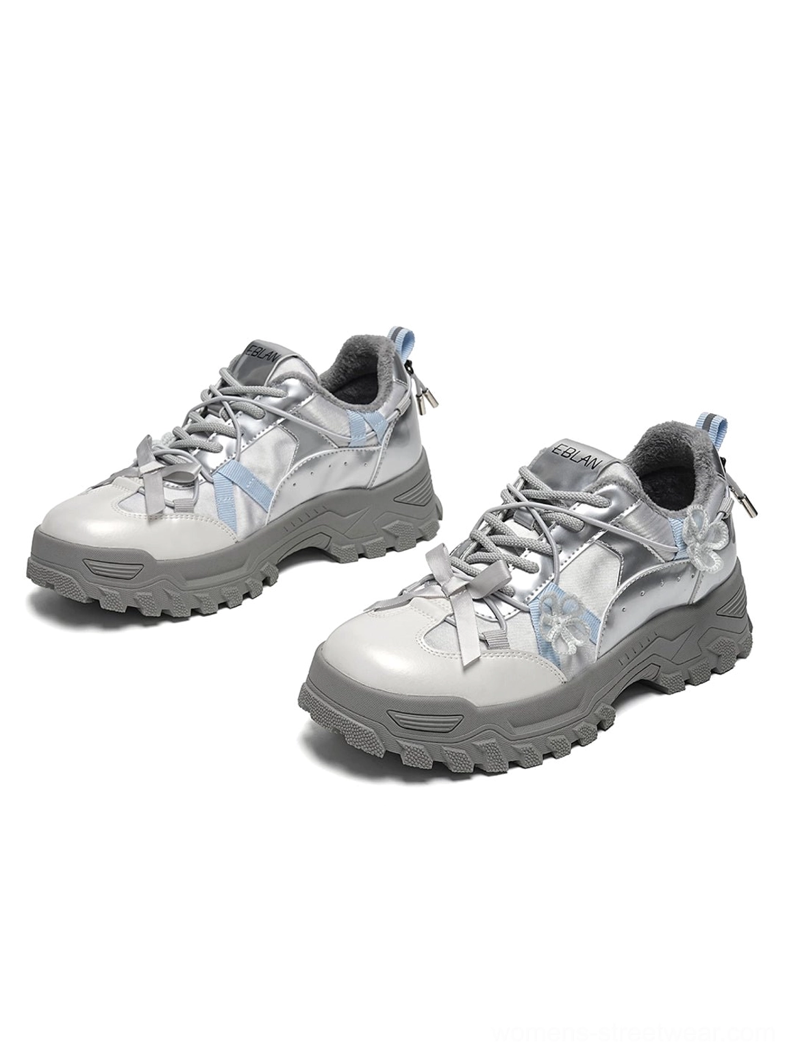 Pair of silver sakura plush chunky trail sneakers showing warm fleece lining metallic technical upper floral lace decorations and chunky lug outsole