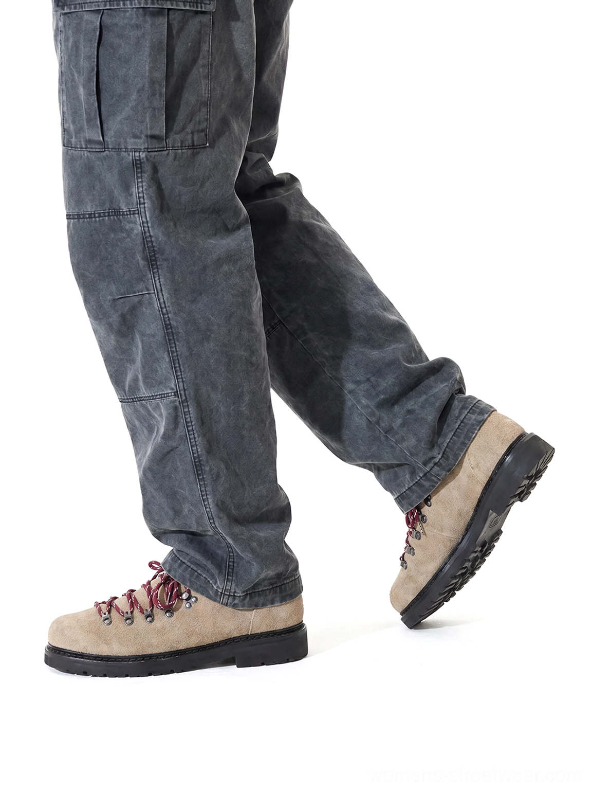 Sand suede hiking-lace derby shoes worn with washed dark grey cargo pants from low rear walking angle