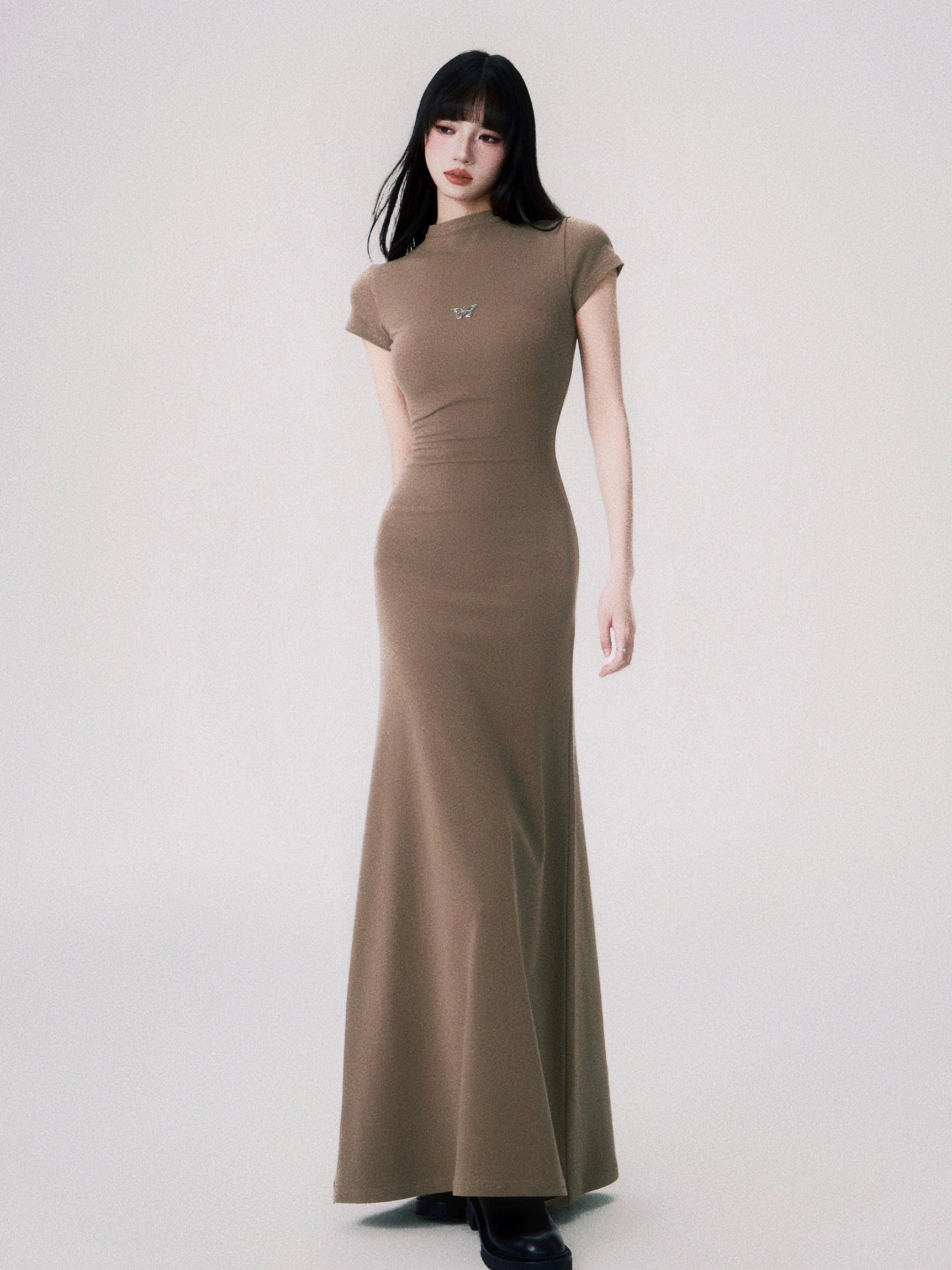 Sand taupe butterfly emblem bodycon maxi dress with mock neck short sleeves and elegant floor length silhouette