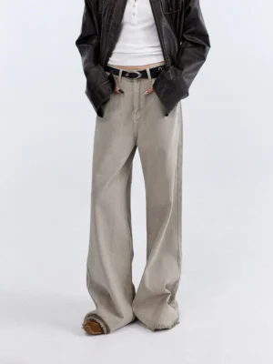 Sandstone beige fringe hem wide-leg jeans shown in a cropped front view against a minimalist white studio background