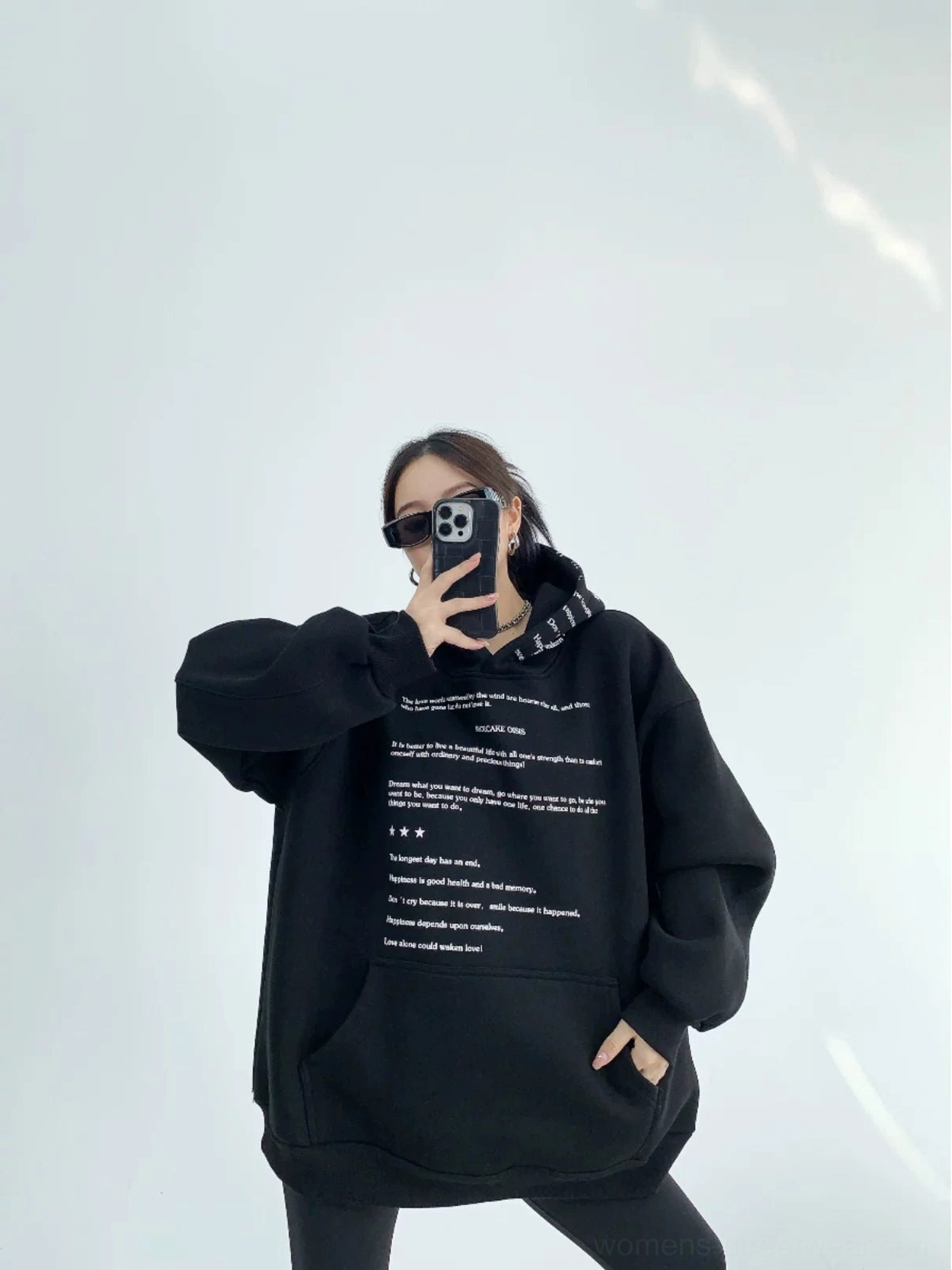 Black oversized script print fleece hoodie front view featuring bold center lettering and front kangaroo pocket