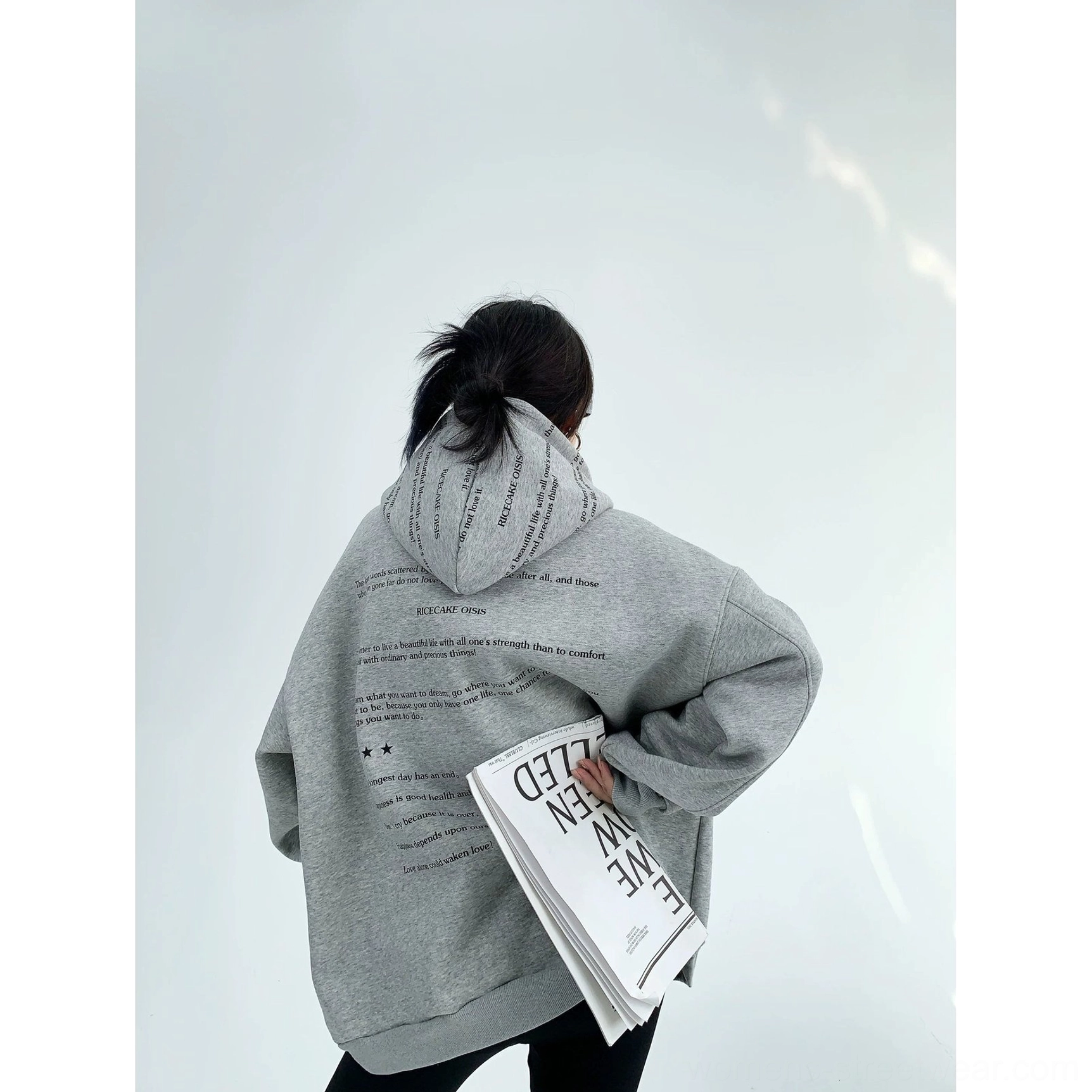 Heather gray script graphic oversized fleece hoodie side back view showing text covered hood and relaxed silhouette