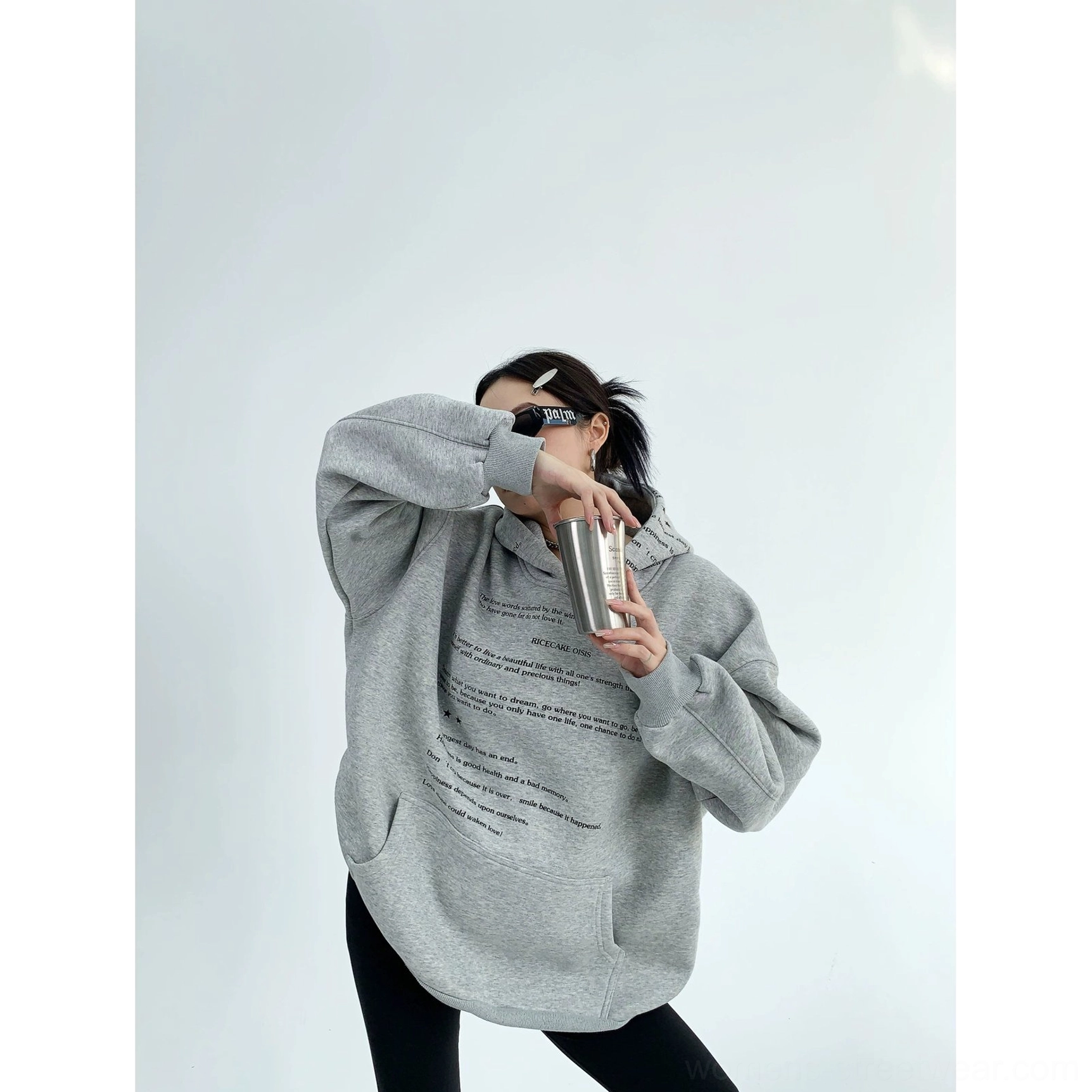 Heather gray oversized drop shoulder graphic hoodie three quarter front view with script print and kangaroo pocket
