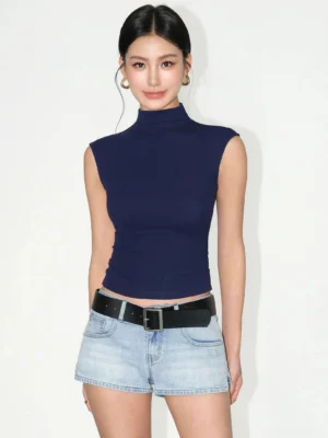 Royal blue sculpted sleeveless mock neck cropped knit top front view styled with light wash denim shorts