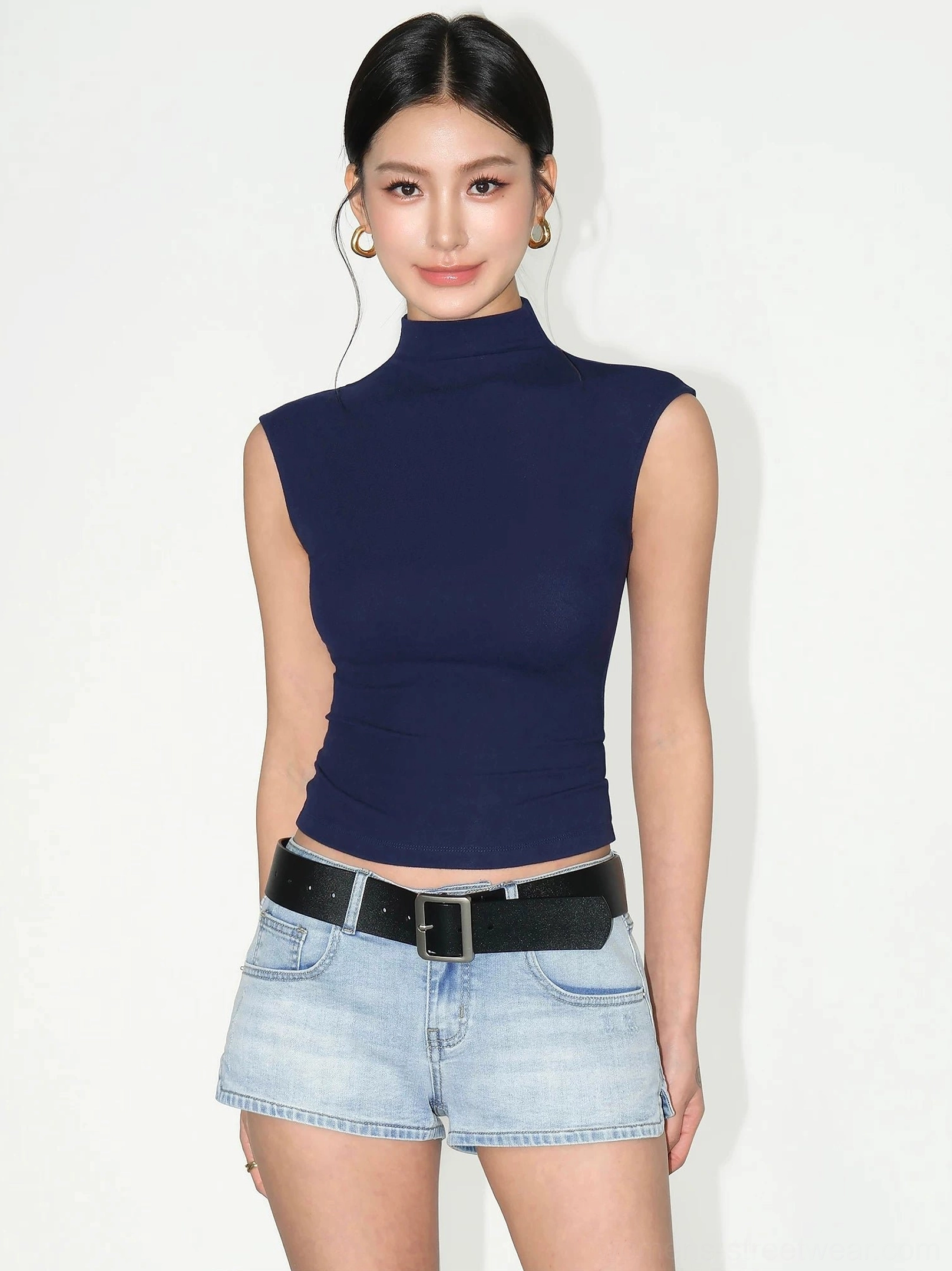 Royal blue sculpted sleeveless mock neck cropped knit top front view styled with light wash denim shorts