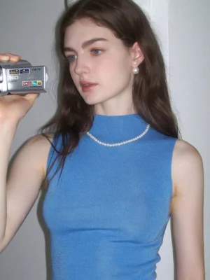 Cerulean blue seamless wool mock neck knit tank top front close-up on female model