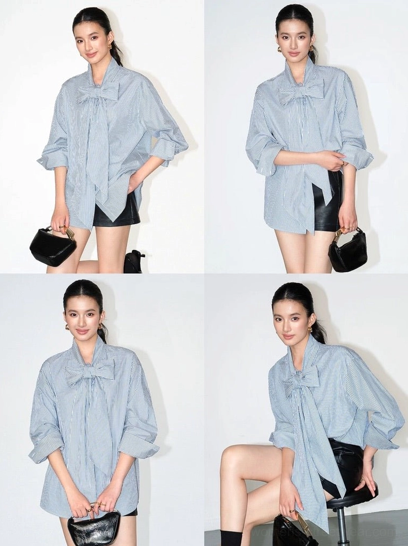 Front view of a relaxed oversized blue pinstripe bow blouse featuring a statement neck tie and contemporary Seoul streetwear proportions