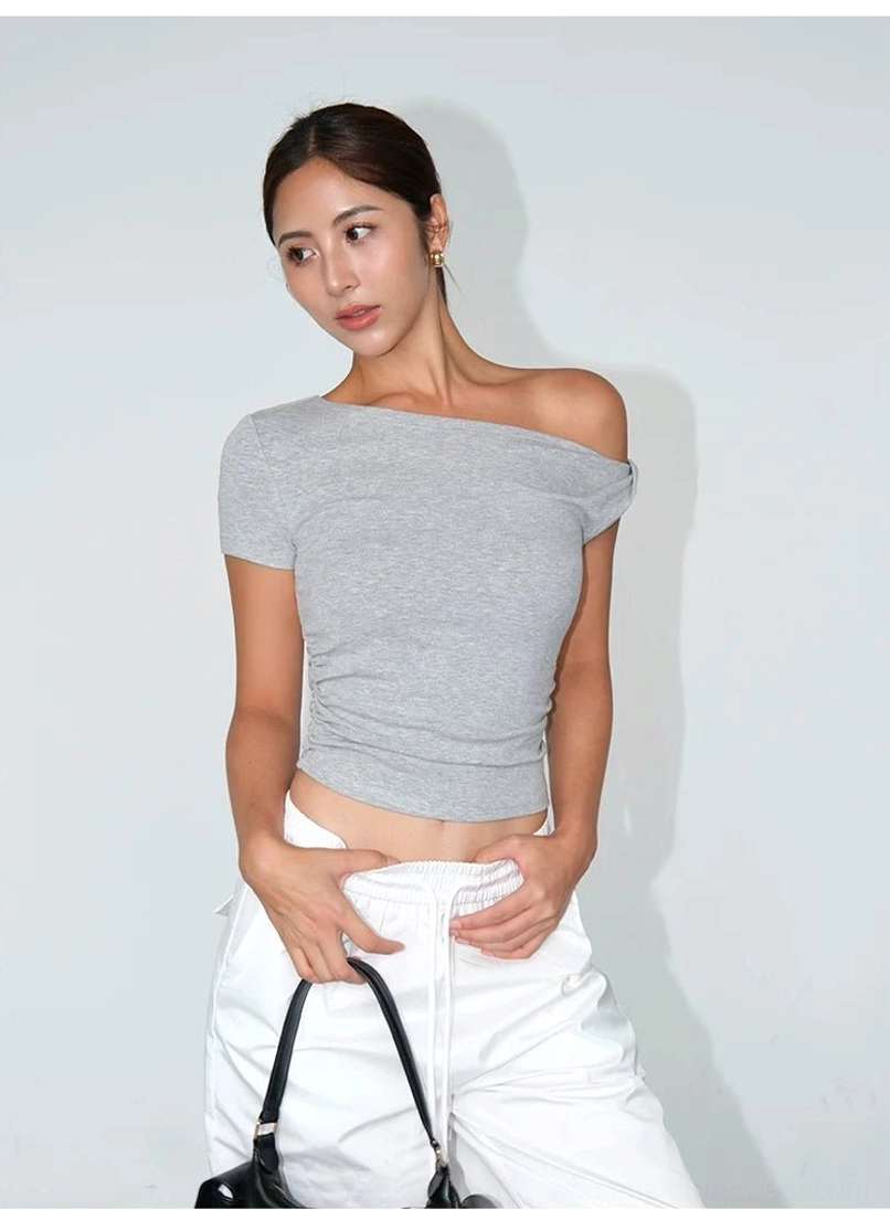 Modern Seoul streetwear one-shoulder crop tee with a diagonal neckline and sculpted waist