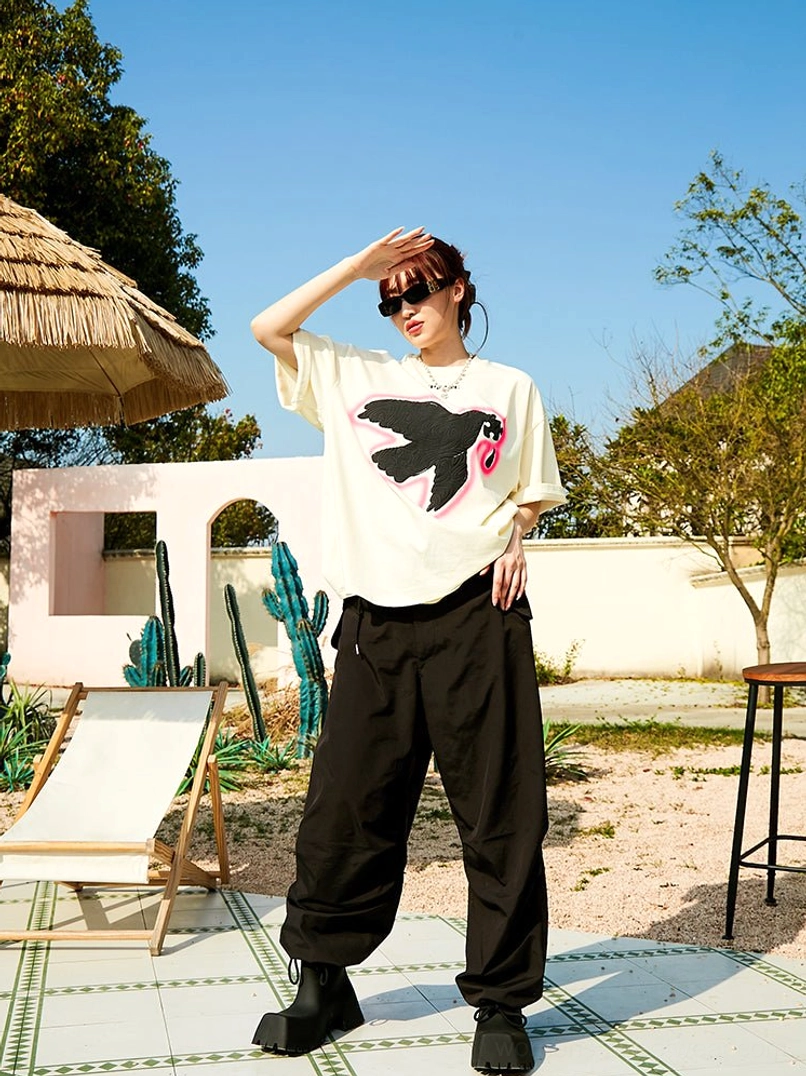 Serene Dove oversized off white graphic T-shirt with black dove motif and pink shadow outline
