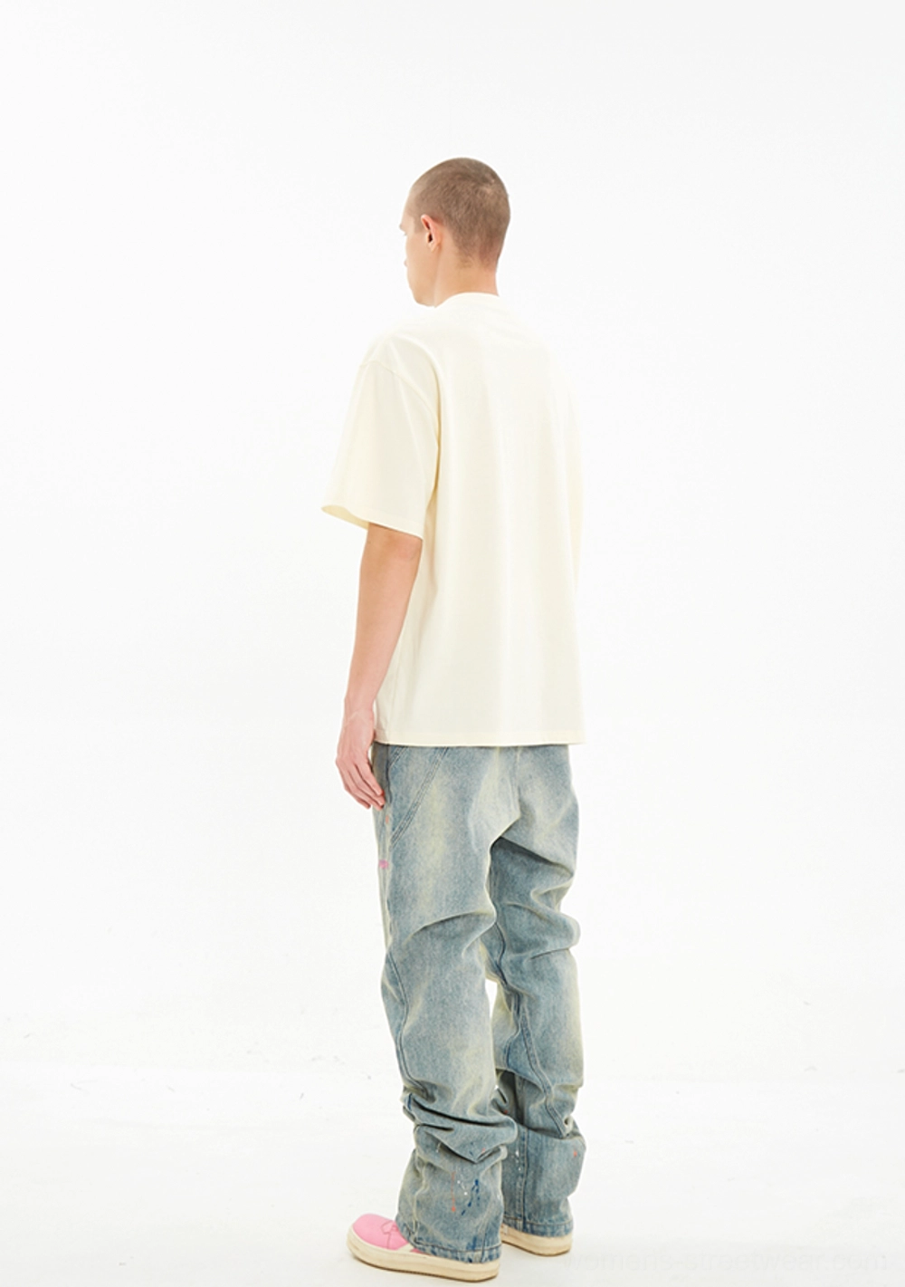 Full body rear view of Serene Dove oversized off white crew neck T-shirt styled with blue jeans
