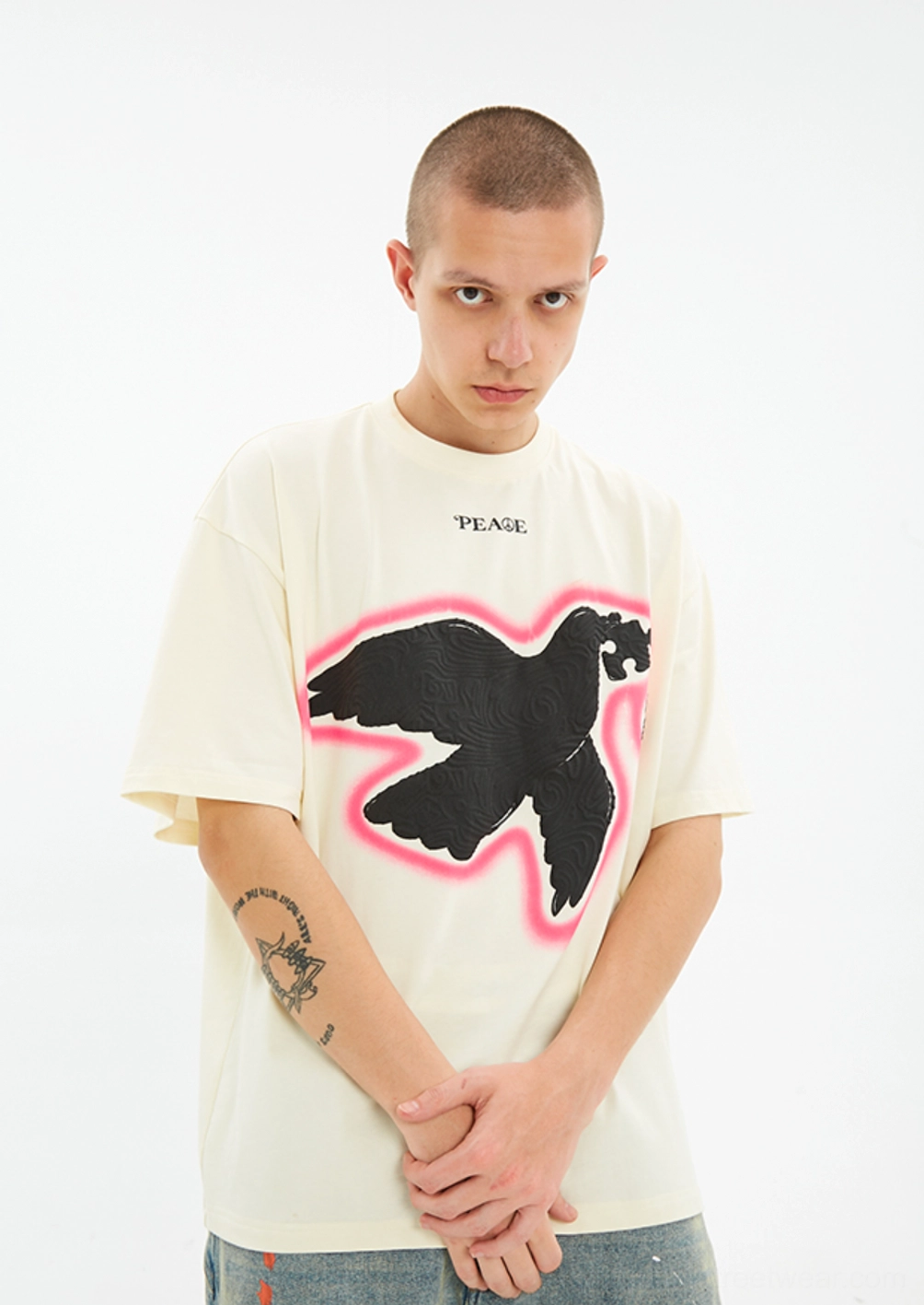 Male model wearing the Serene Dove off white oversized suede foam print T-shirt in a close front view